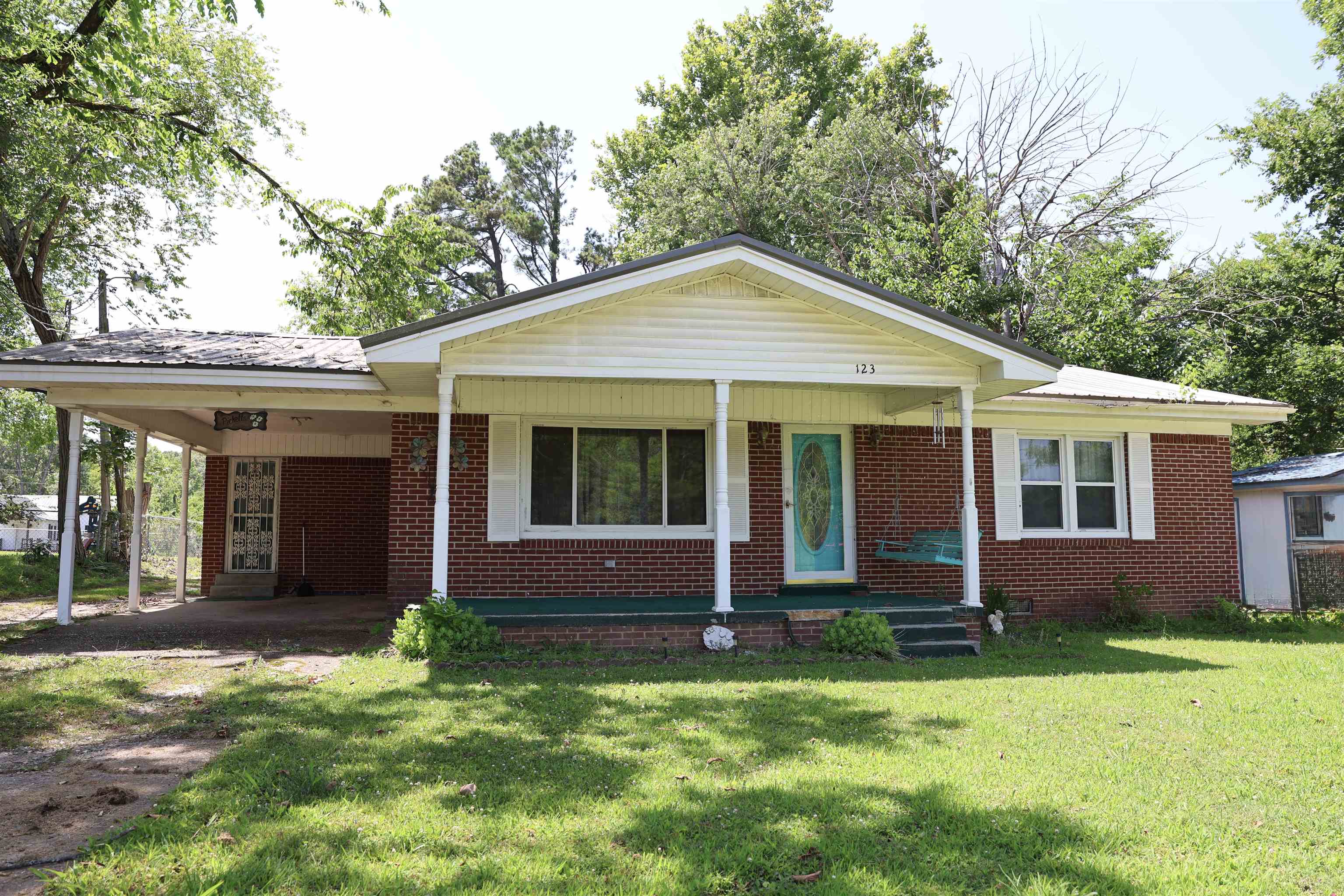 123 North Magnolia Street Adamsville, TN 38310 - Photo 3 of 25 a front view of a house with a yard