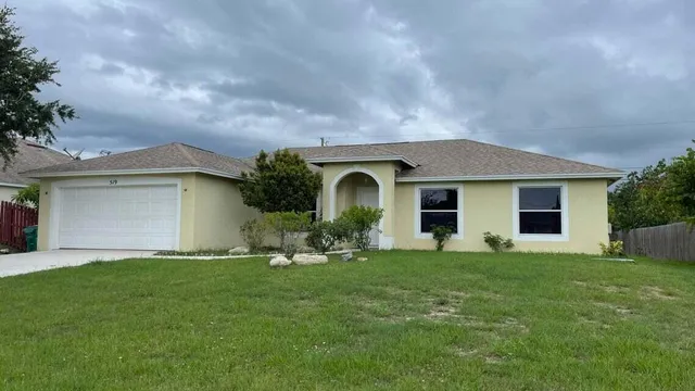 a front view of a house with a yard and garage
