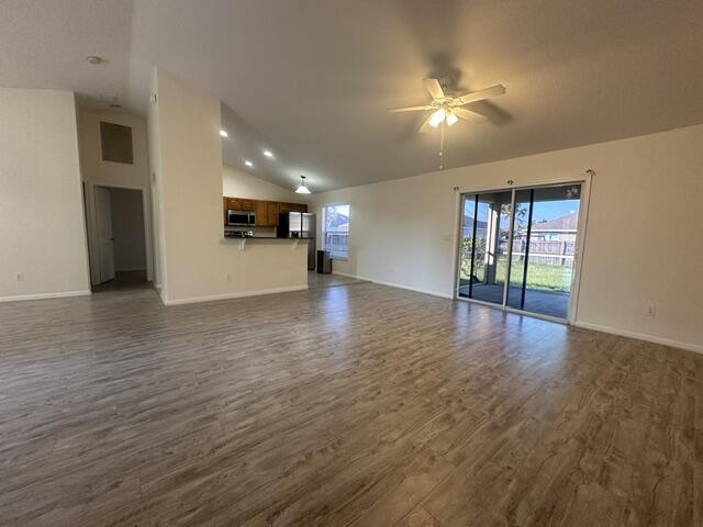 519 Southwest Laconic Avenue Port St. Lucie, FL 34953 - Photo 2 of 10 a view of an empty room with window and wooden floor