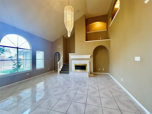 a view of a livingroom with a fireplace and window
