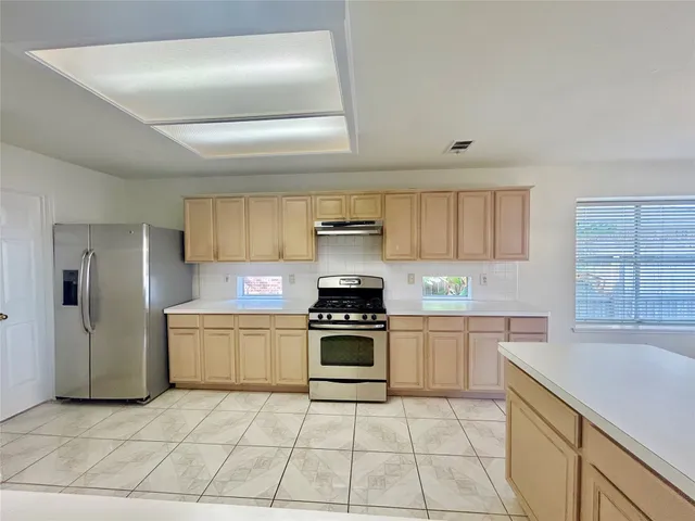 a kitchen with stainless steel appliances granite countertop a stove and a sink