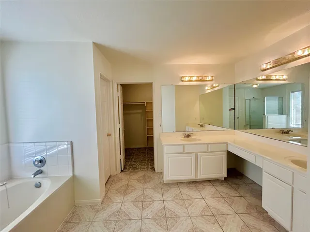 a bathroom with a bathtub and shower