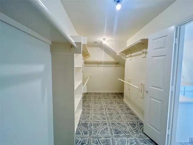 a open kitchen with cabinets and wooden floor