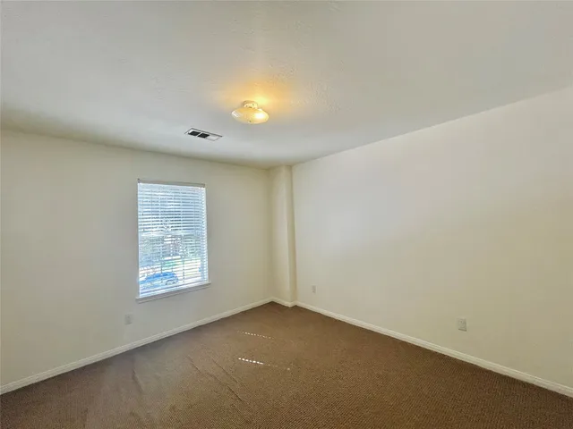 an empty room with a fan