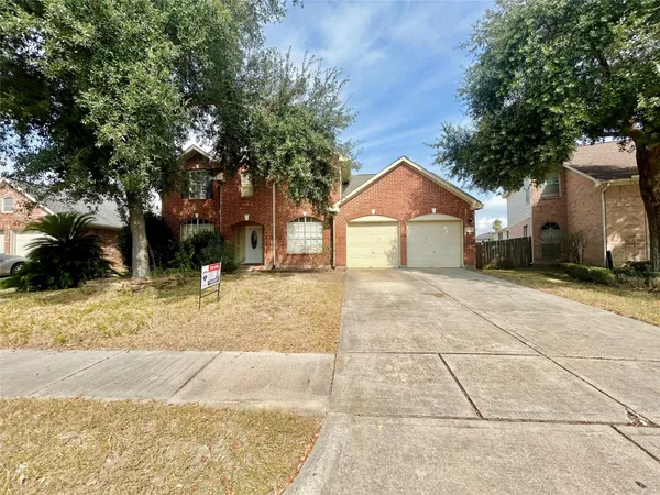 a backyard of a house with yard and tree
