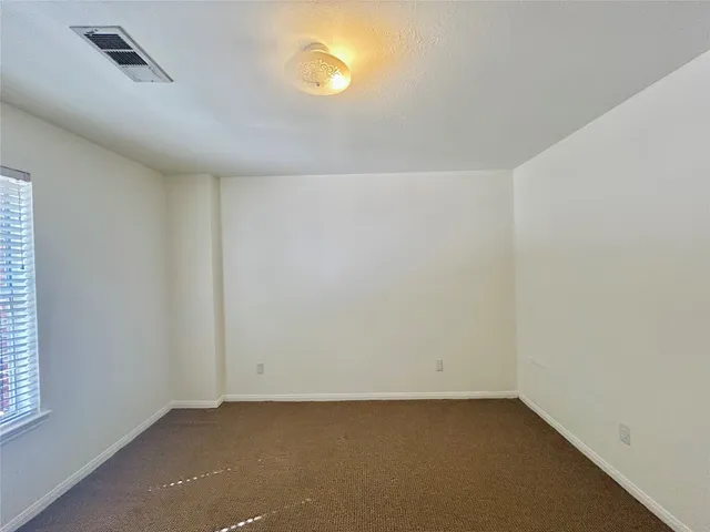 a bathroom with a granite countertop sink a mirror and a shower