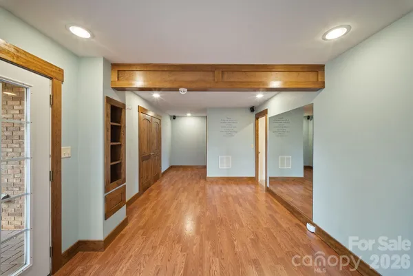 a view of hallway with wooden floor