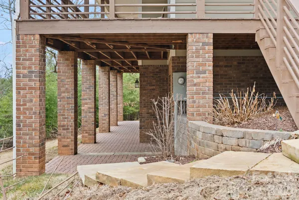 a balcony with chairs and wooden floor