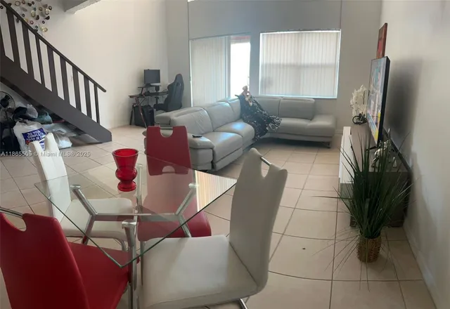 a living room with furniture rug and a window
