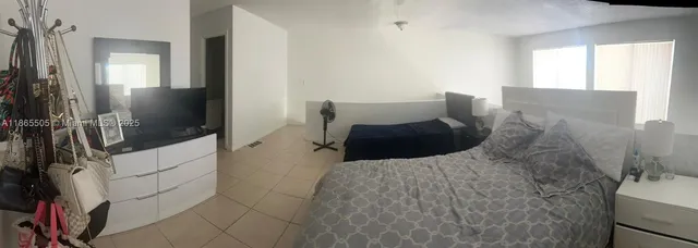 a bedroom with a bed and a mirror