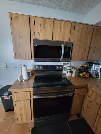a kitchen with a stove and a microwave