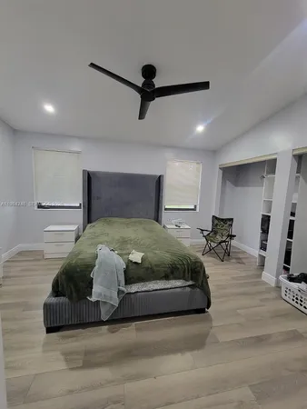 a bedroom with a bed and a mirror