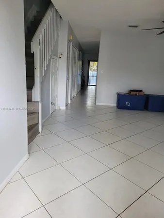 a view of a livingroom with an empty space and a stove top oven