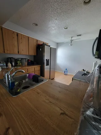 a bedroom with a bed and a view of kitchen
