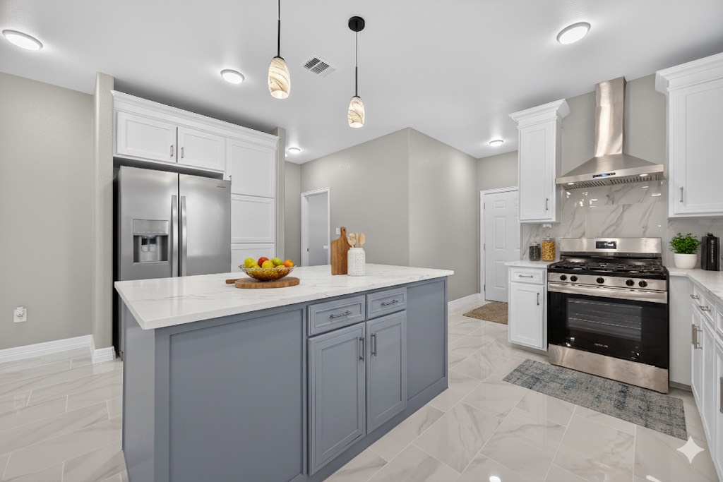 a kitchen with stainless steel appliances granite countertop a sink a stove and a refrigerator