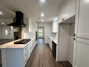 a kitchen with stainless steel appliances kitchen island a white stove sink and cabinets