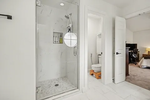 a bathroom with a sink a toilet and shower