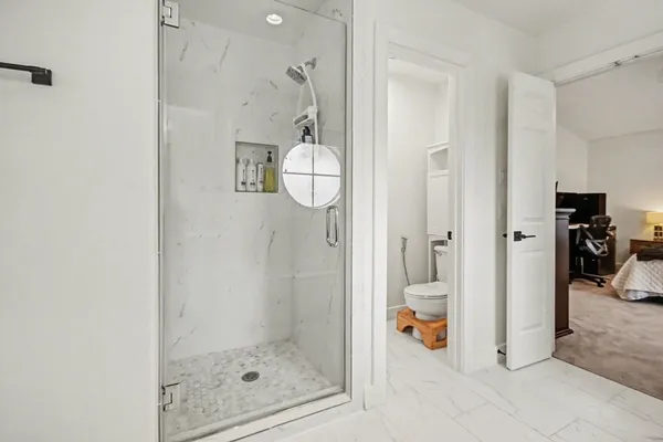 a bathroom with a sink a toilet and shower