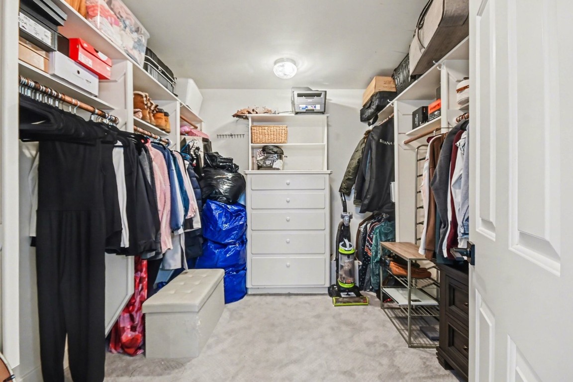 1470 Springrock Lane, Unit 6 Houston, TX 77055 - Photo 19 of 32 a view of walk in closet with clothes