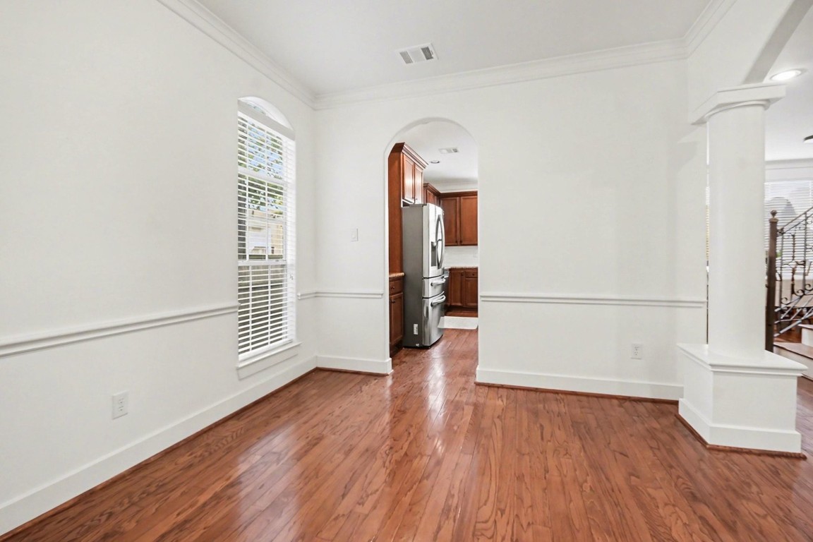 1470 Springrock Lane, Unit 6 Houston, TX 77055 - Photo 25 of 32 an empty room with wooden floor and a window