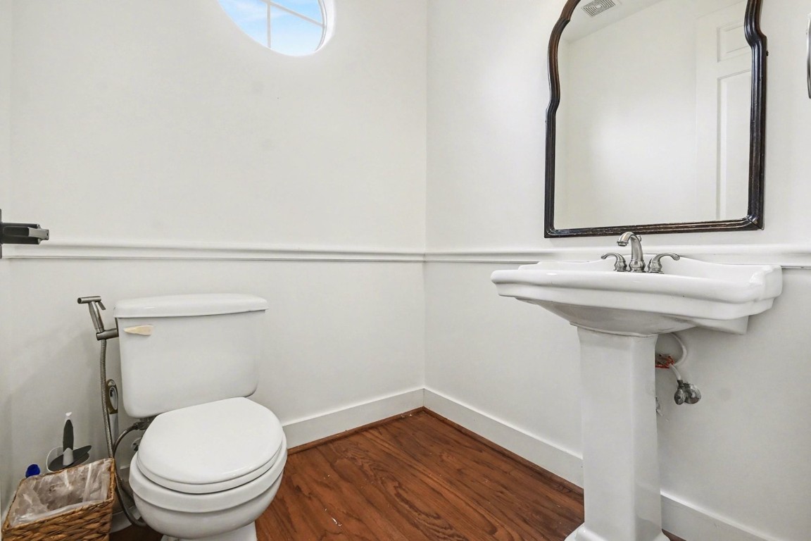 1470 Springrock Lane, Unit 6 Houston, TX 77055 - Photo 26 of 32 a bathroom with a sink a toilet and mirror