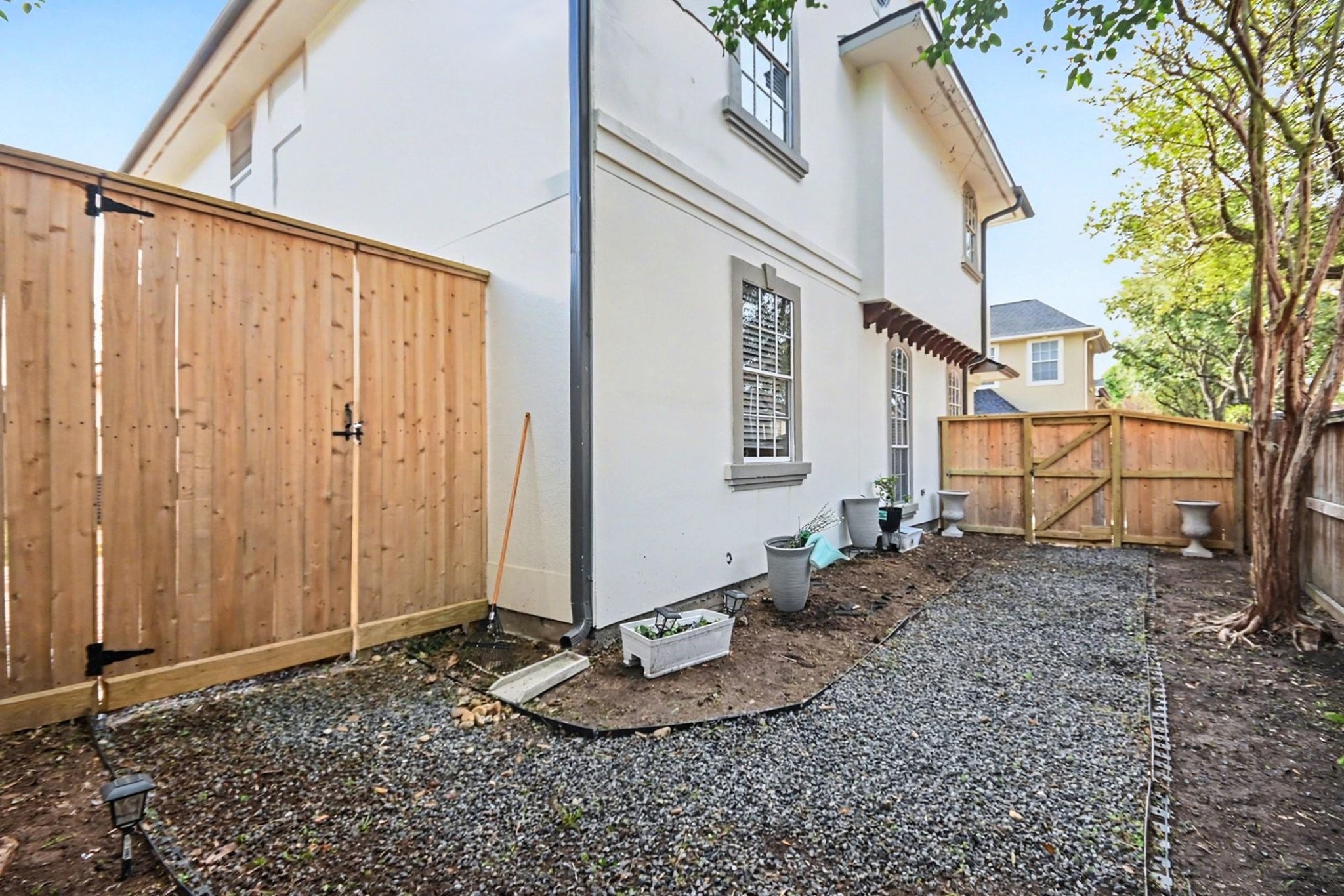 1470 Springrock Lane, Unit 6 Houston, TX 77055 - Photo 30 of 32 Side yard with additional fencing, creating a separate and functional outdoor space from the backyard.