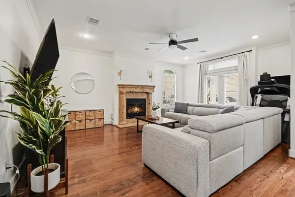 a living room with furniture fireplace and a potted plant