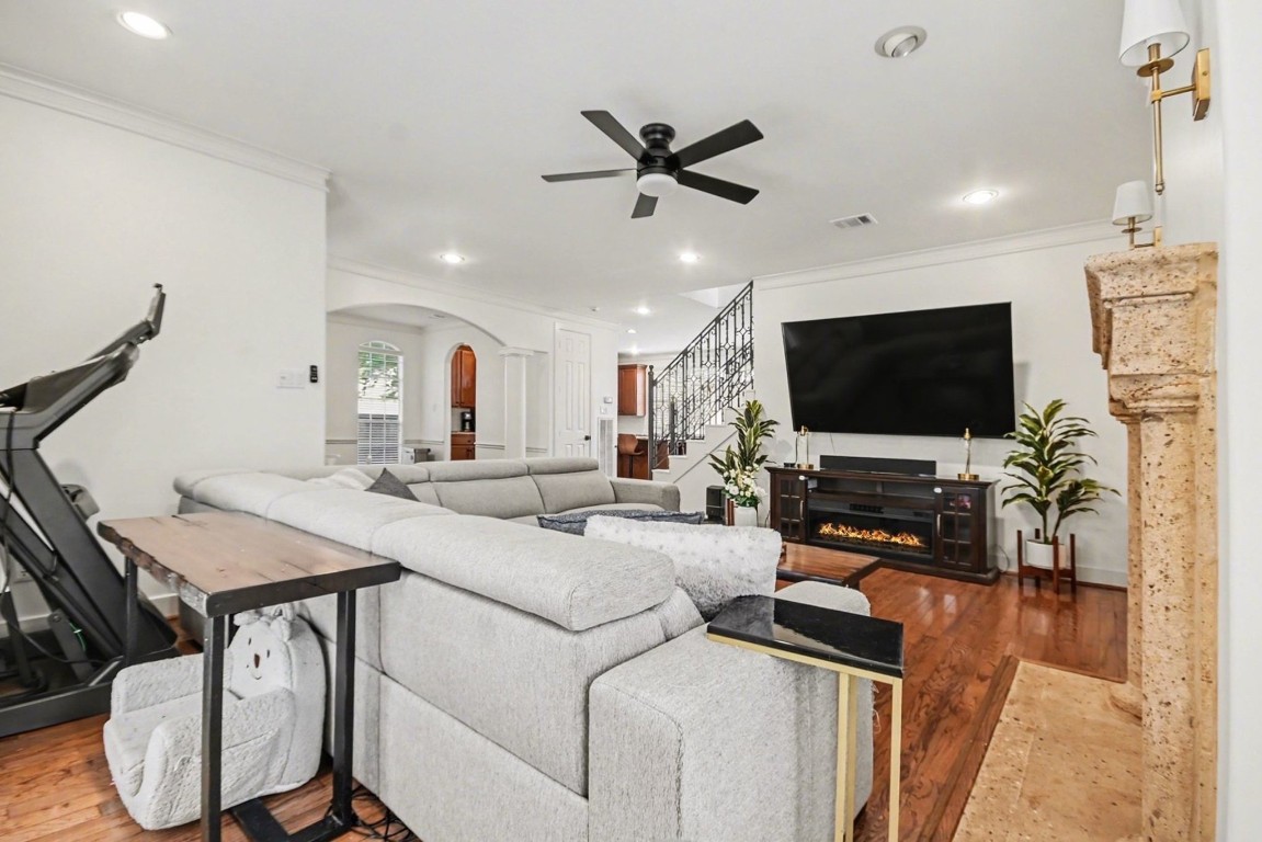 1470 Springrock Lane, Unit 6 Houston, TX 77055 - Photo 5 of 32 This spacious living area features hardwood floors, a cozy fireplace, high ceilings, crown molding, and large windows that fill the room with natural light.