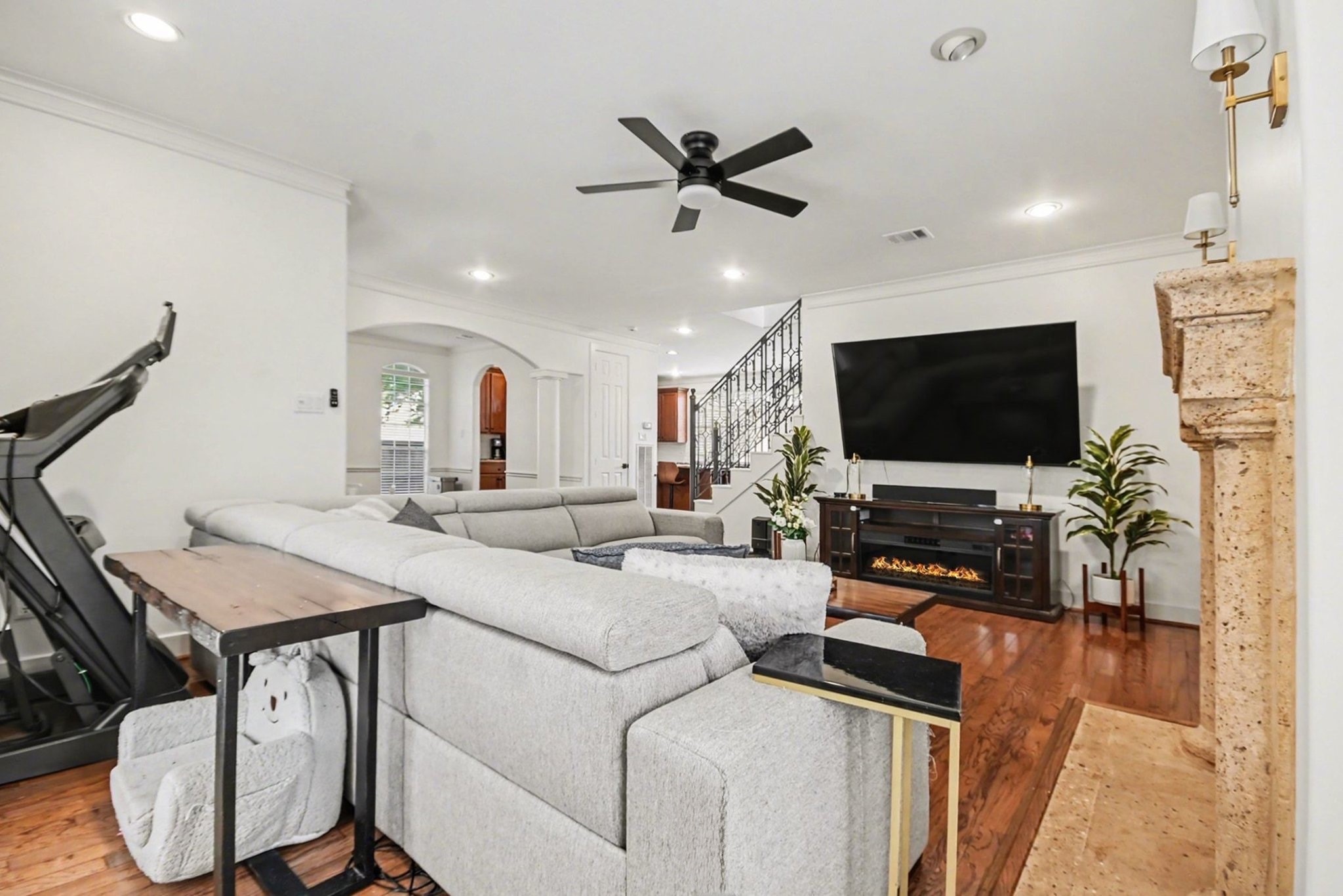1470 Springrock Lane, Unit 6 Houston, TX 77055 - Photo 5 of 32 This spacious living area features hardwood floors, a cozy fireplace, high ceilings, crown molding, and large windows that fill the room with natural light.