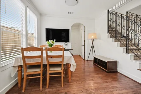 a view of a dining room with furniture window and wooden floor