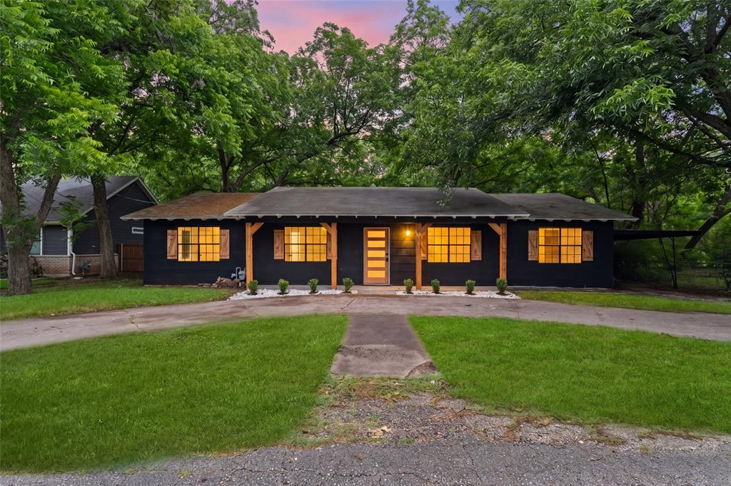 110 Hackberry Street Lancaster, TX 75146 - Photo 6 of 32 Contemporary dark-toned exterior with a covered front porch featuring natural wood columns
