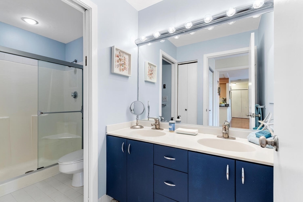 100 Rosemary Way, Unit 325 Needham, MA 02494 - Photo 12 of 24 a bathroom with a double vanity sink toilet and shower