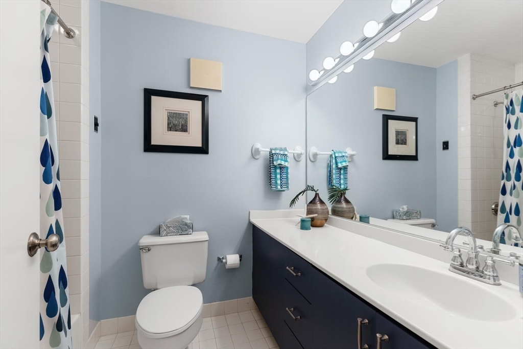 100 Rosemary Way, Unit 325 Needham, MA 02494 - Photo 16 of 24 a bathroom with a toilet a sink a mirror and vanity