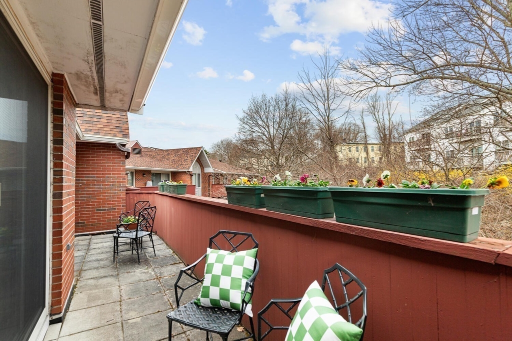 100 Rosemary Way, Unit 325 Needham, MA 02494 - Photo 17 of 24 a view of a chairs and table in patio