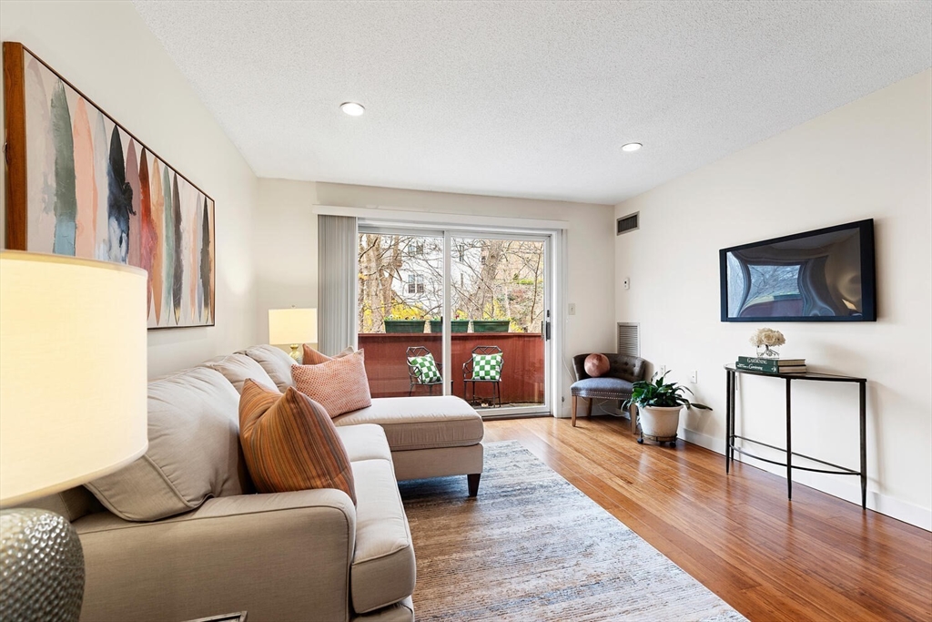 100 Rosemary Way, Unit 325 Needham, MA 02494 - Photo 2 of 24 a living room with furniture and a flat screen tv