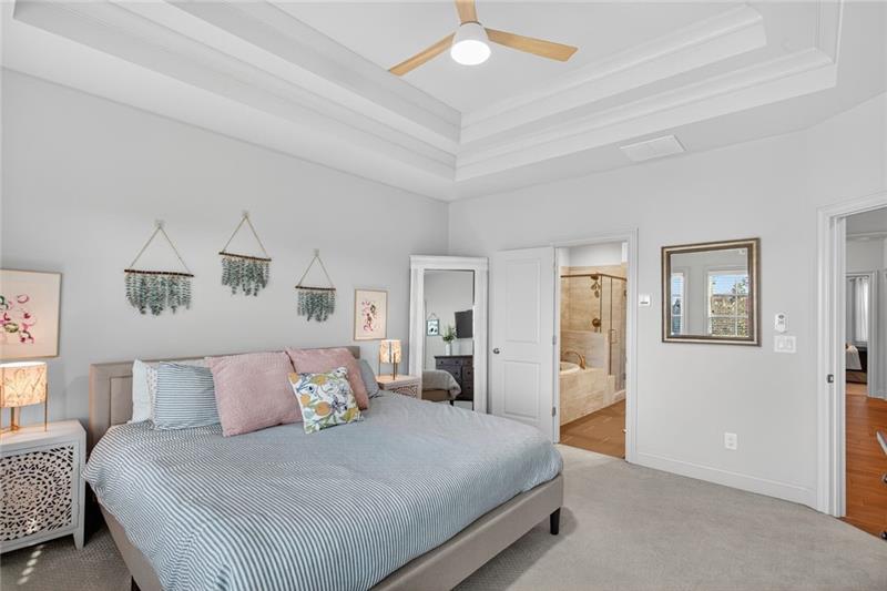 1956 Skyfall Circle Atlanta, GA 30319 - Photo 14 of 49 a bedroom with a large bed and a chandelier