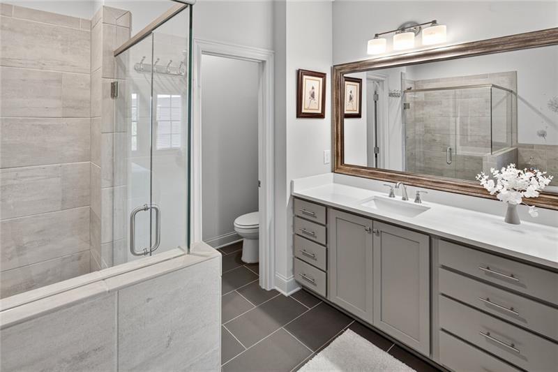 1956 Skyfall Circle Atlanta, GA 30319 - Photo 20 of 49 a bathroom with a double vanity sink and mirror with shower