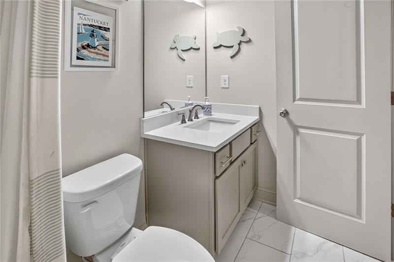 1956 Skyfall Circle Atlanta, GA 30319 - Photo 26 of 49 a bathroom with a toilet sink and mirror