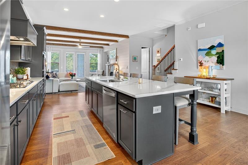 1956 Skyfall Circle Atlanta, GA 30319 - Photo 8 of 49 a kitchen with kitchen island granite countertop a sink stove and wooden cabinets