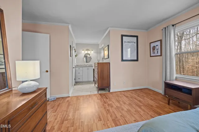 a bathroom with a granite countertop sink mirror vanity and toilet