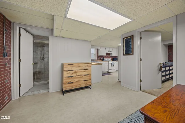 a kitchen with stainless steel appliances sink a stove and white cabinets