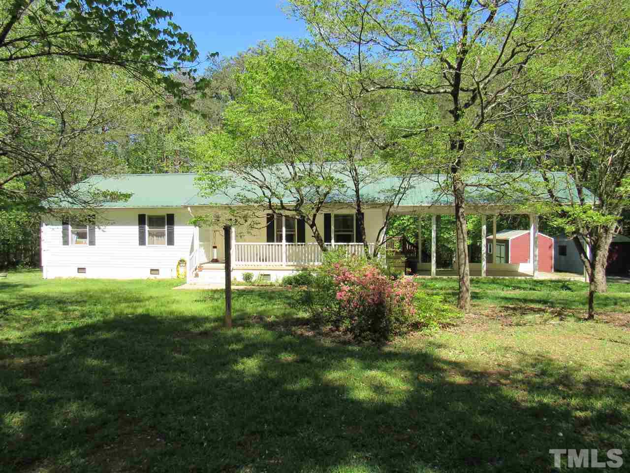 7204 Jock Road Bahama, NC 27503 - Photo 2 of 25 a backyard of a house with table and chairs