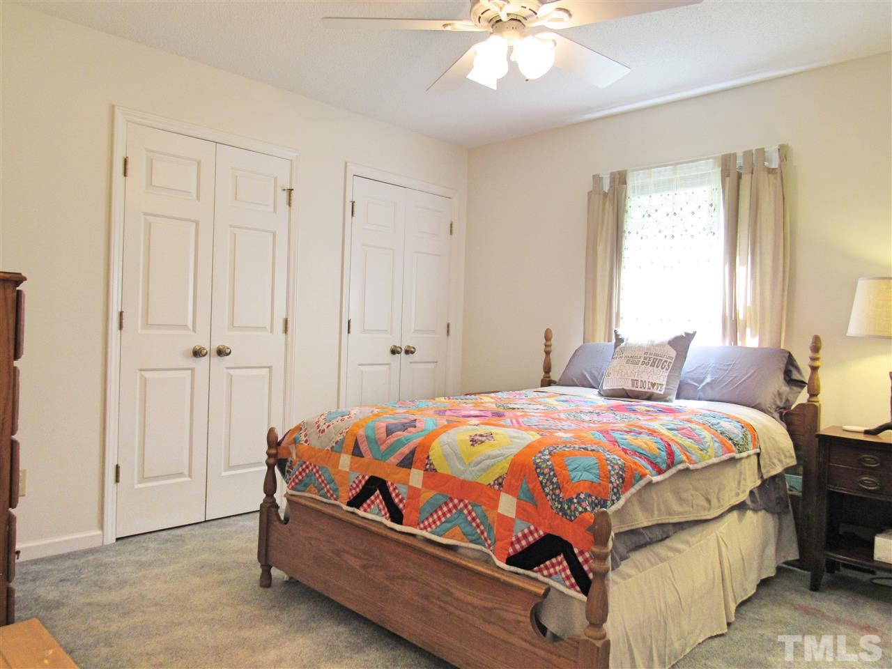 7204 Jock Road Bahama, NC 27503 - Photo 12 of 25 a bedroom with a bed and a chandelier