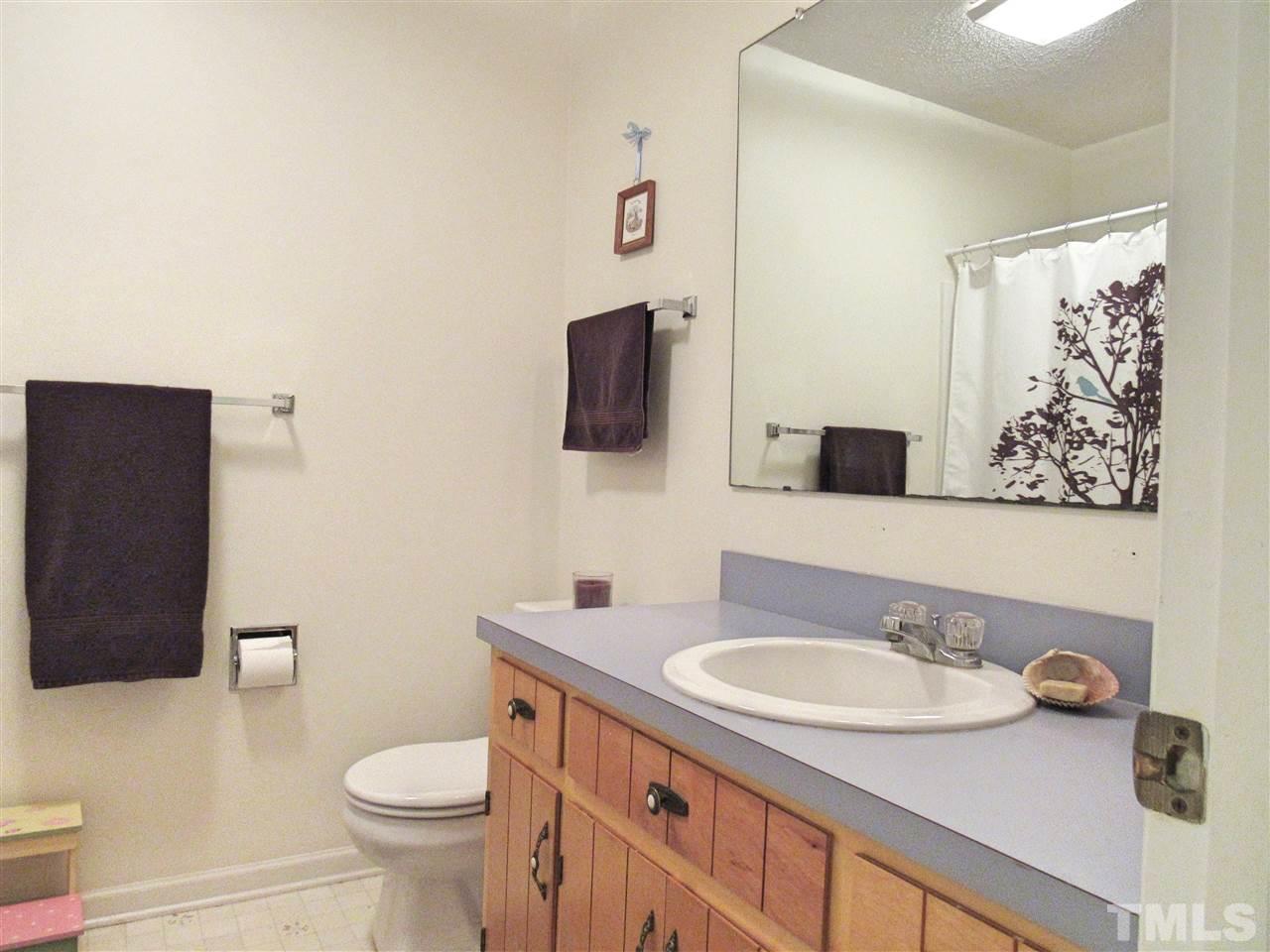 7204 Jock Road Bahama, NC 27503 - Photo 13 of 25 a bathroom with a granite countertop sink and a mirror