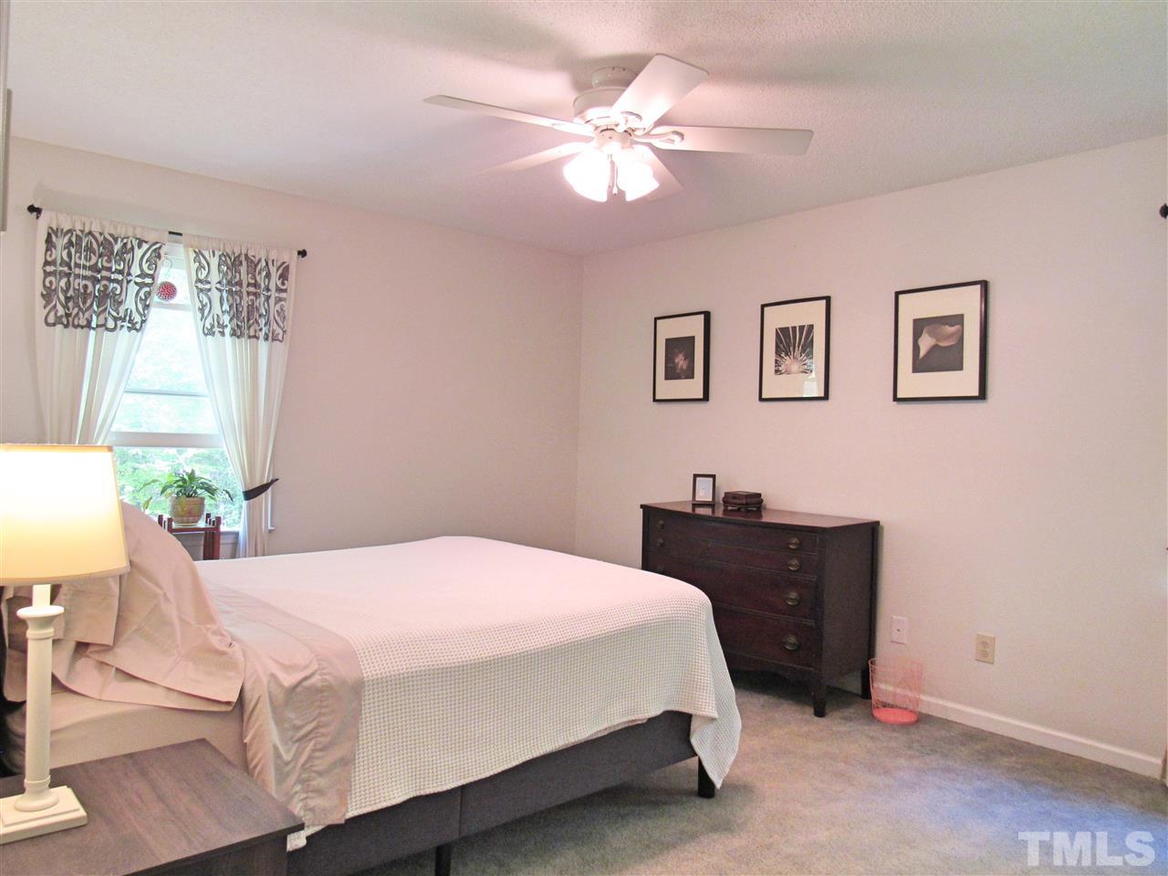 7204 Jock Road Bahama, NC 27503 - Photo 15 of 25 a bedroom with a bed and a chandelier