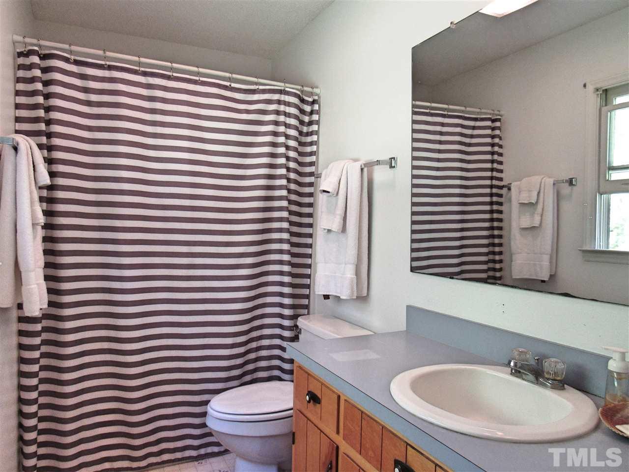 7204 Jock Road Bahama, NC 27503 - Photo 17 of 25 a bathroom with a sink a toilet and mirror