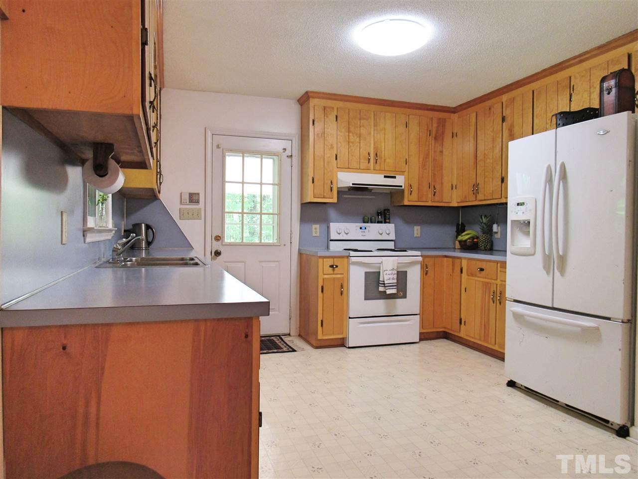7204 Jock Road Bahama, NC 27503 - Photo 9 of 25 a kitchen with a sink a stove and a refrigerator