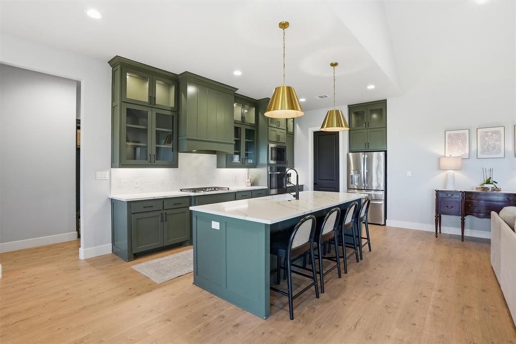 6620 Buffalo Ridge Circle Godley, TX 76044 - Photo 12 of 40 a kitchen with a sink a counter space and stainless steel appliances
