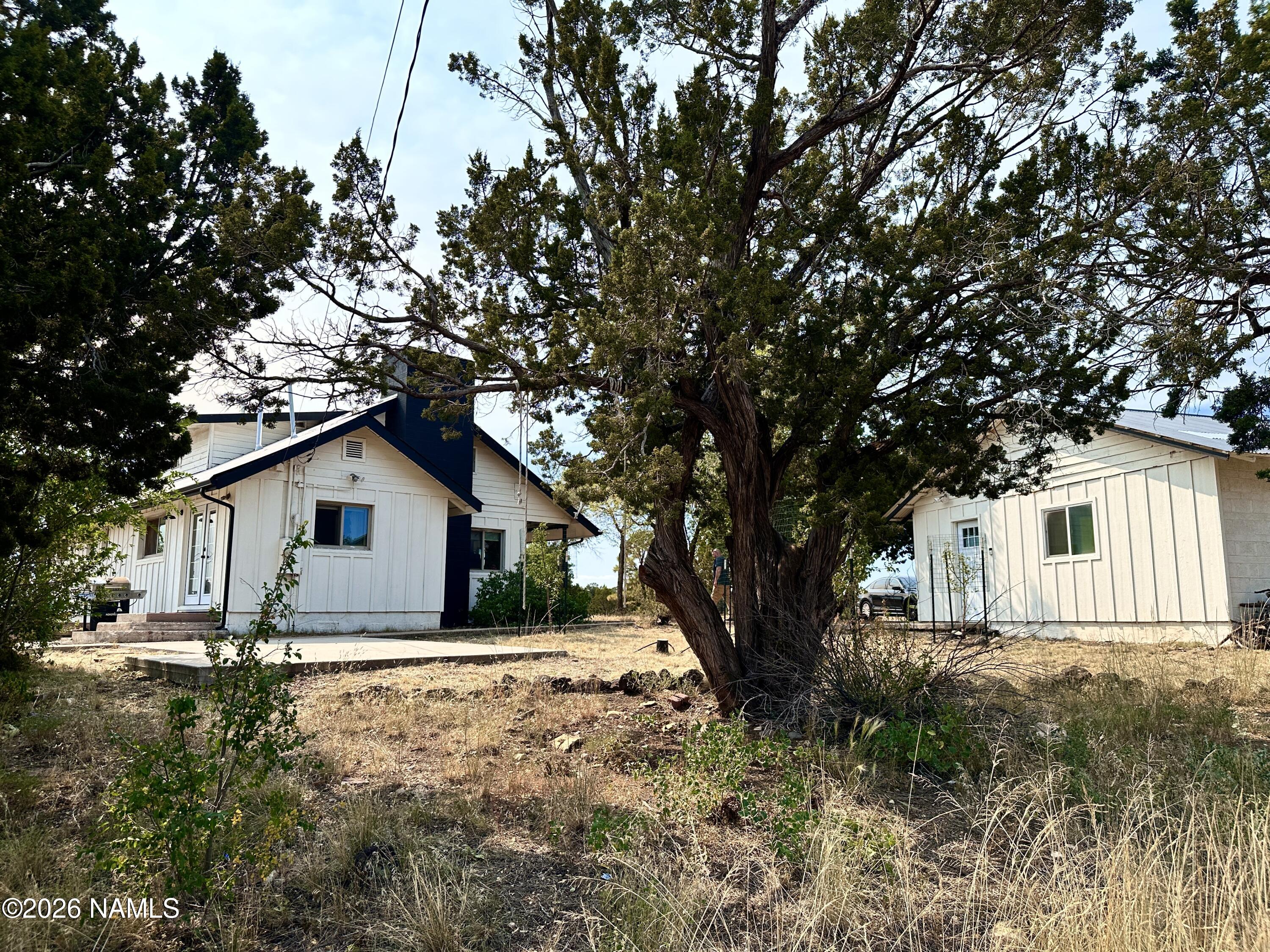 12851 Townsend-Winona Road Flagstaff, AZ 86004 - Photo 23 of 31 a white house that has a tree in front of it