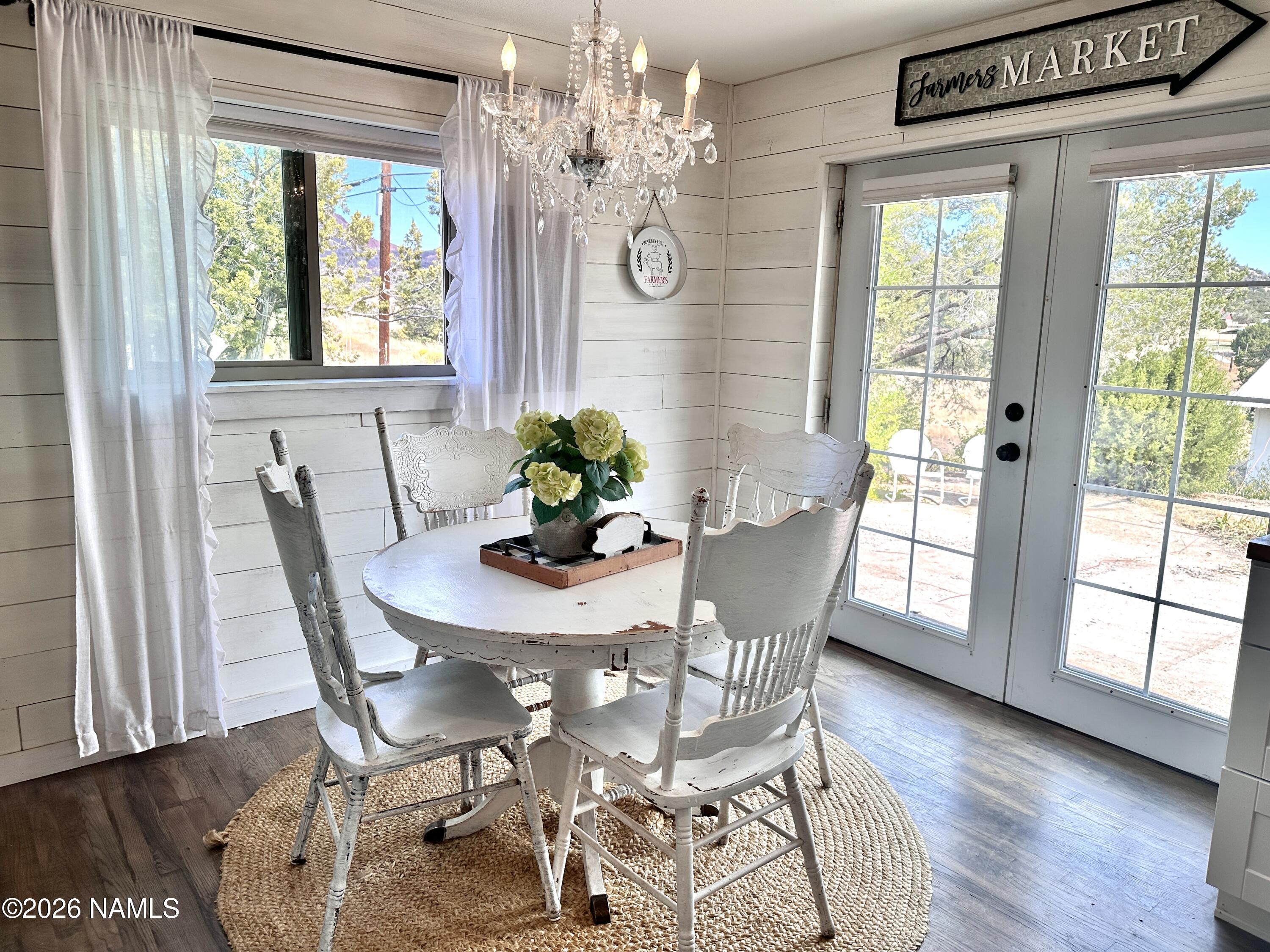 12851 Townsend-Winona Road Flagstaff, AZ 86004 - Photo 5 of 31 a dining room with furniture a chandelier and wooden floor
